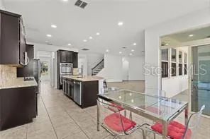 a view of kitchen with furniture and refrigerator