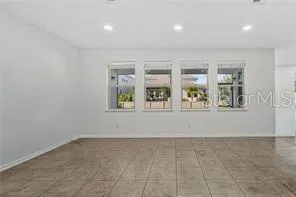 a kitchen with granite countertop a refrigerator and a stove top oven
