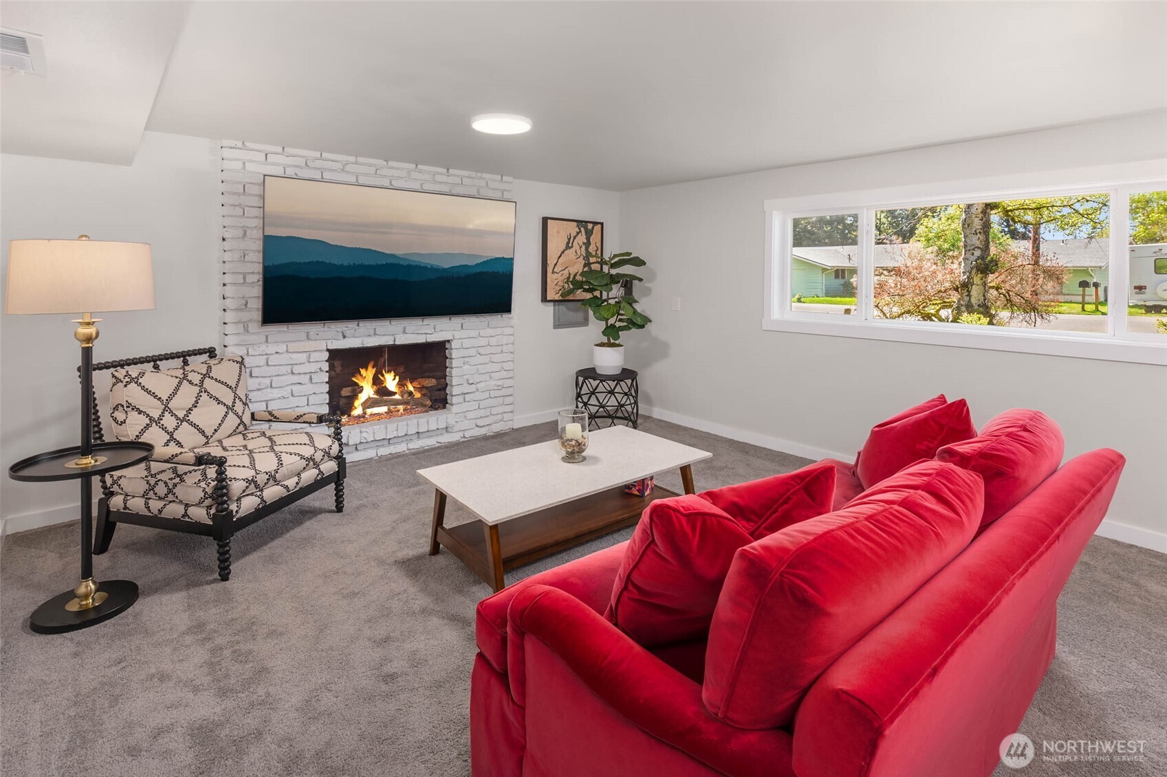 11019 23rd Drive Southeast Everett, WA 98208 - Photo 26 of 35 a living room with furniture a flat screen tv and a large window