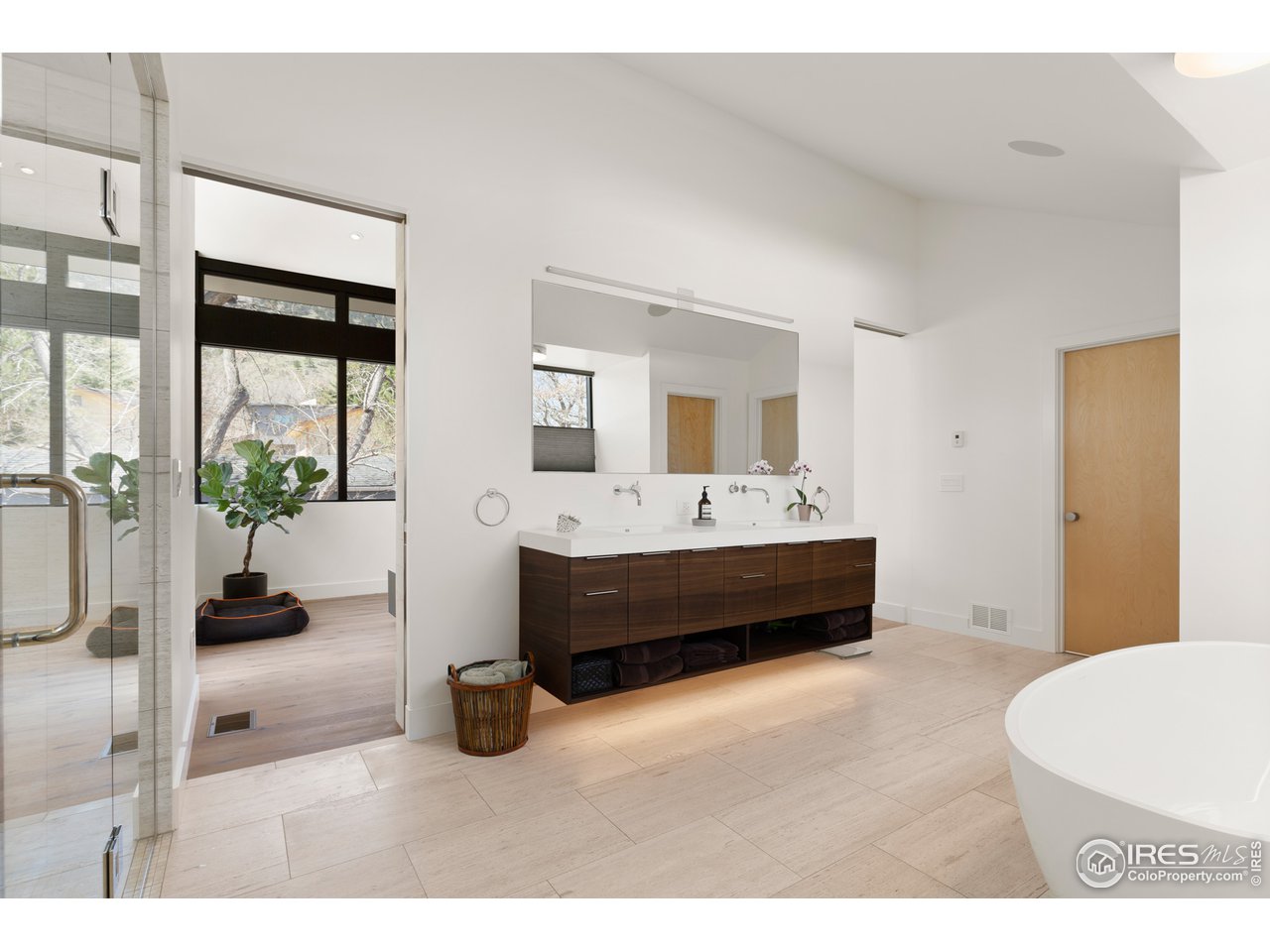 550 Iris Avenue Boulder, CO 80304 - Photo 18 of 39 a en suite bathroom with a double vanity sink a mirror and a shower