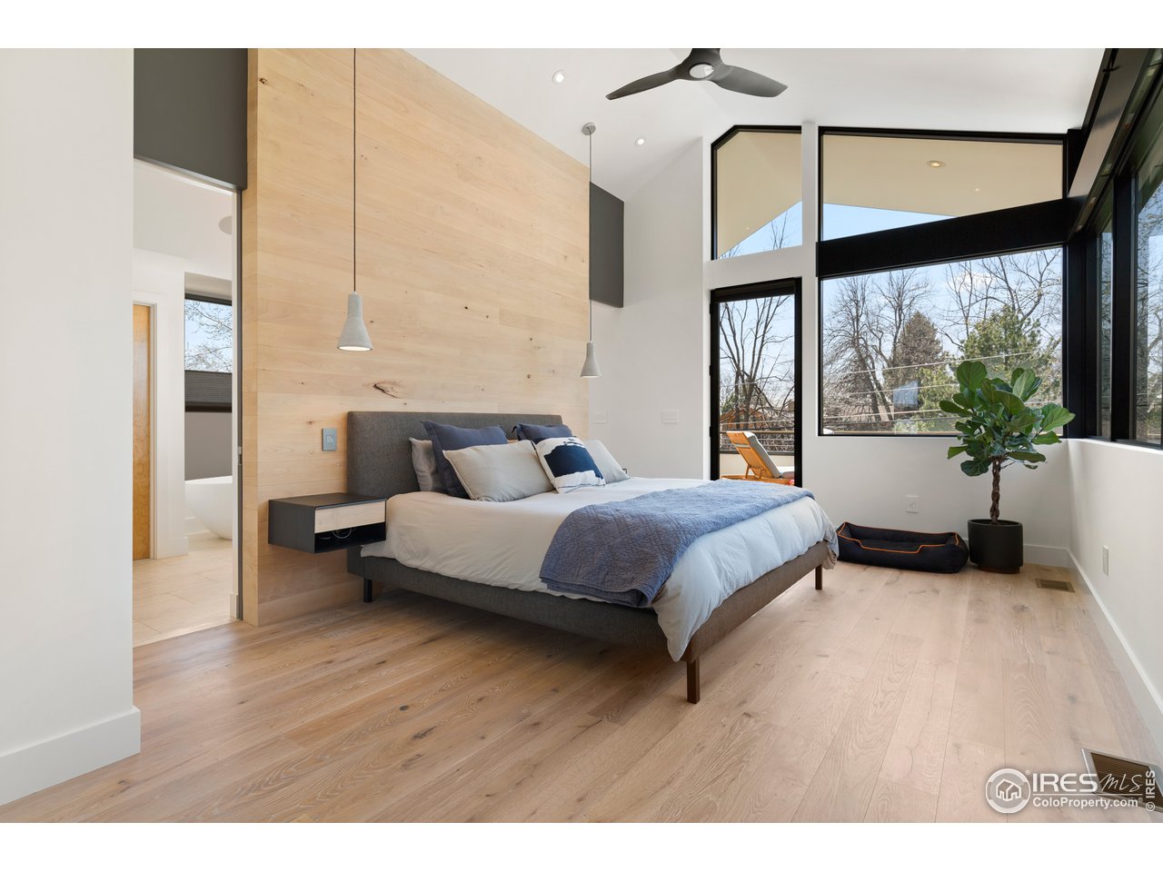 550 Iris Avenue Boulder, CO 80304 - Photo 21 of 39 a spacious bedroom with a bed and a large window