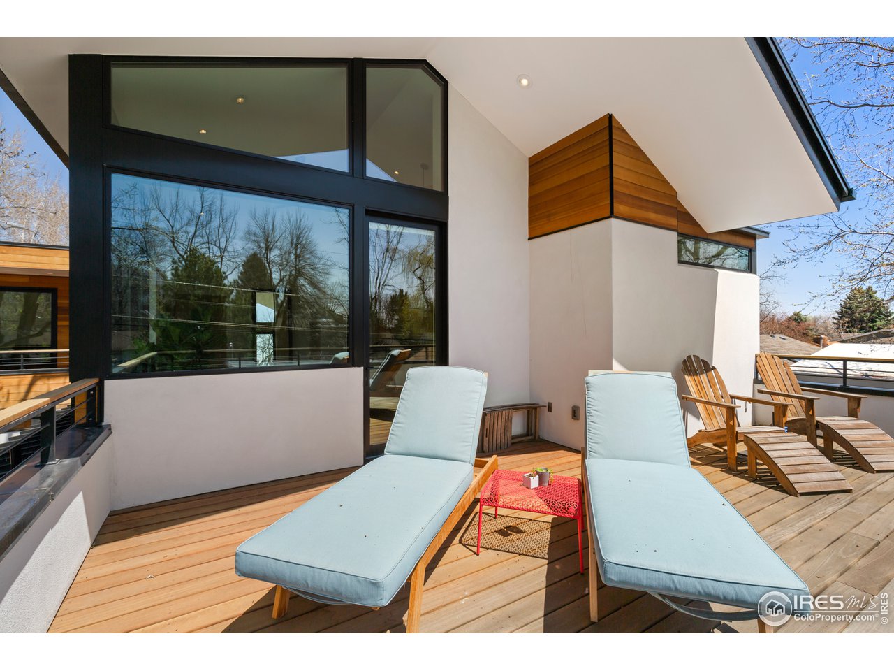 550 Iris Avenue Boulder, CO 80304 - Photo 22 of 39 a view of a patio with table and chairs with wooden floor and fence