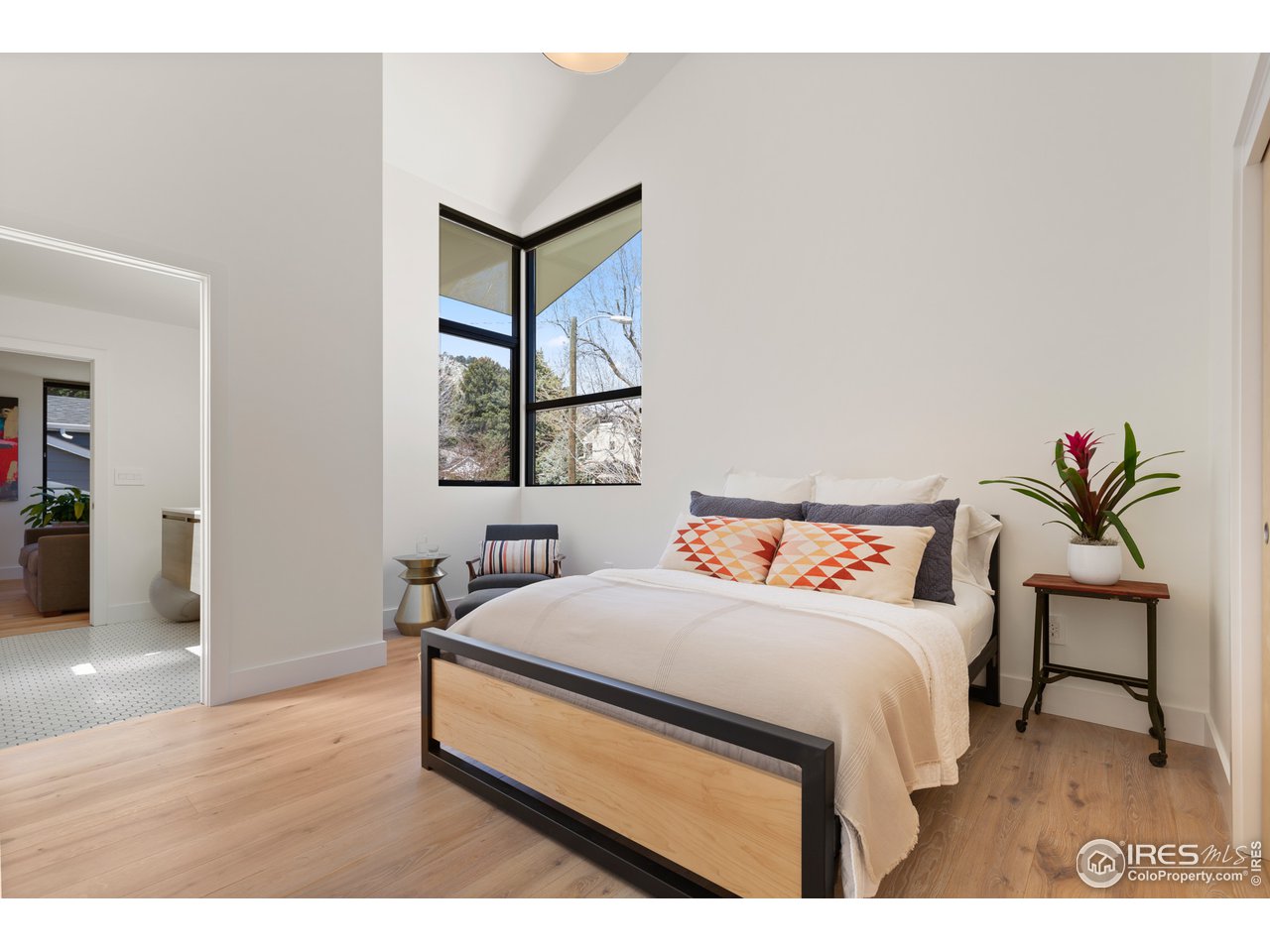 550 Iris Avenue Boulder, CO 80304 - Photo 24 of 39 a bedroom with a bed and a painting on the wall