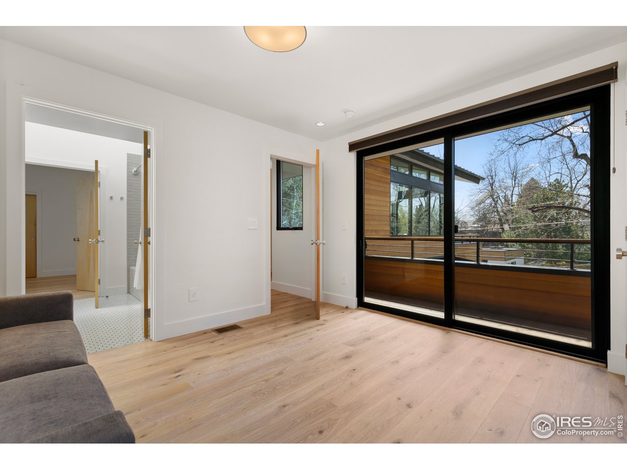 550 Iris Avenue Boulder, CO 80304 - Photo 25 of 39 a view of an empty room with wooden floor and a window