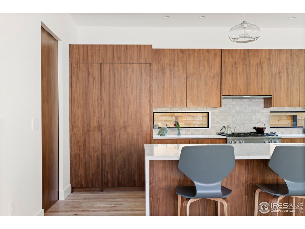 550 Iris Avenue Boulder, CO 80304 - Photo 5 of 39 a kitchen with a table chairs sink and cabinets