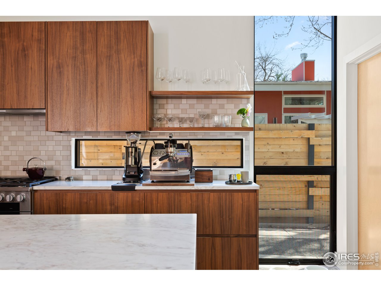 550 Iris Avenue Boulder, CO 80304 - Photo 7 of 39 a kitchen with stainless steel appliances kitchen island granite countertop a refrigerator and stove