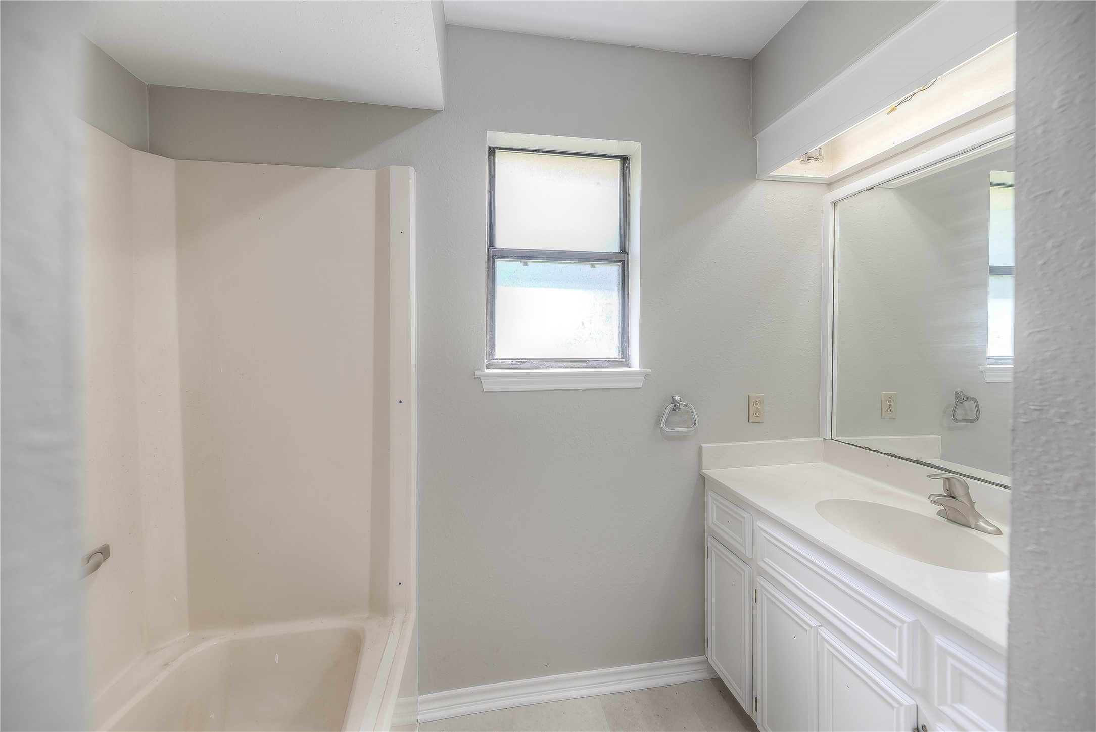438 Bird Road Livingston, TX 77351 - Photo 12 of 37 a bathroom with a sink a bathtub and a vanity