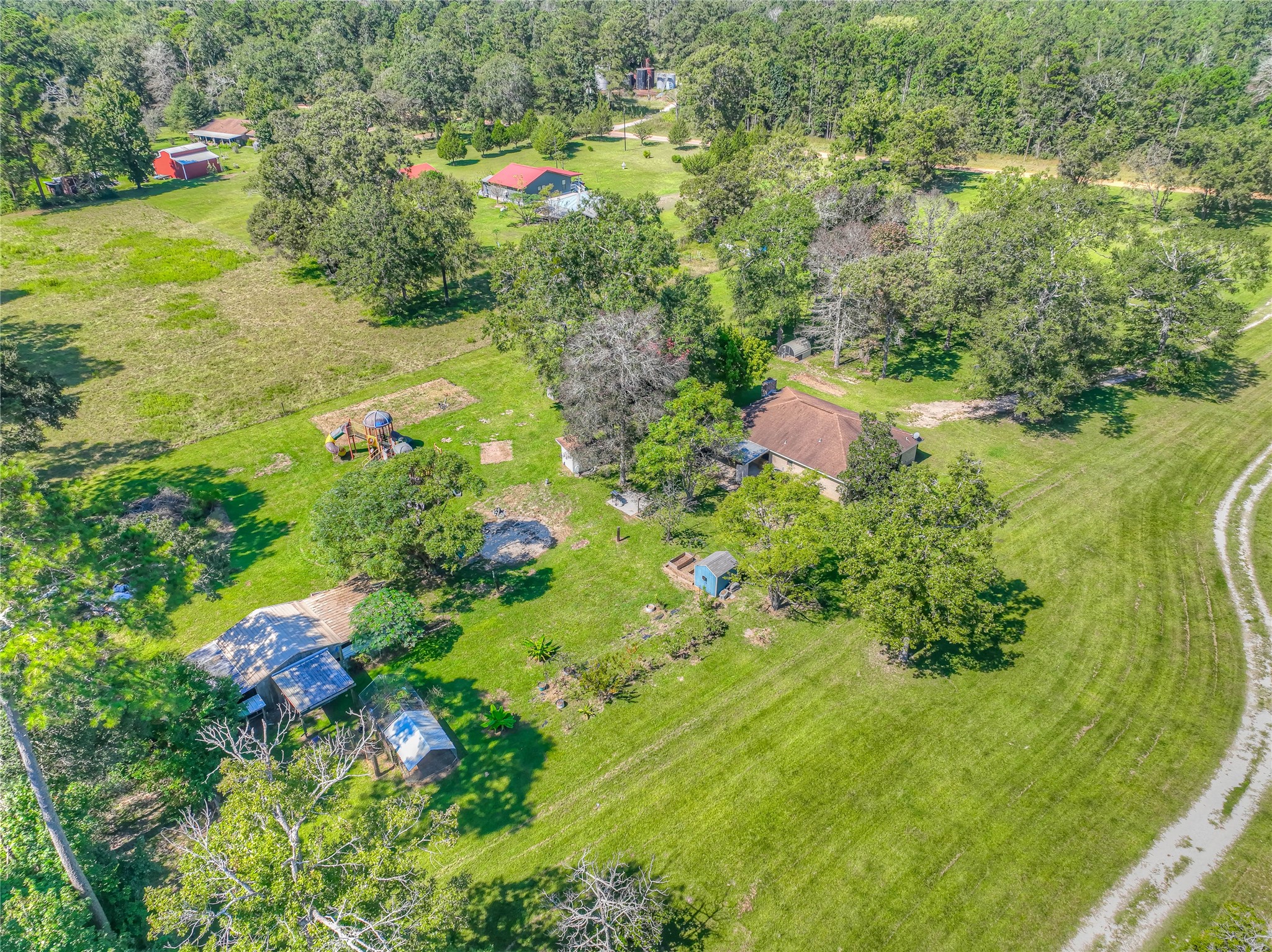 438 Bird Road Livingston, TX 77351 - Photo 34 of 37 a backyard of a house with a yard and fountain in middle