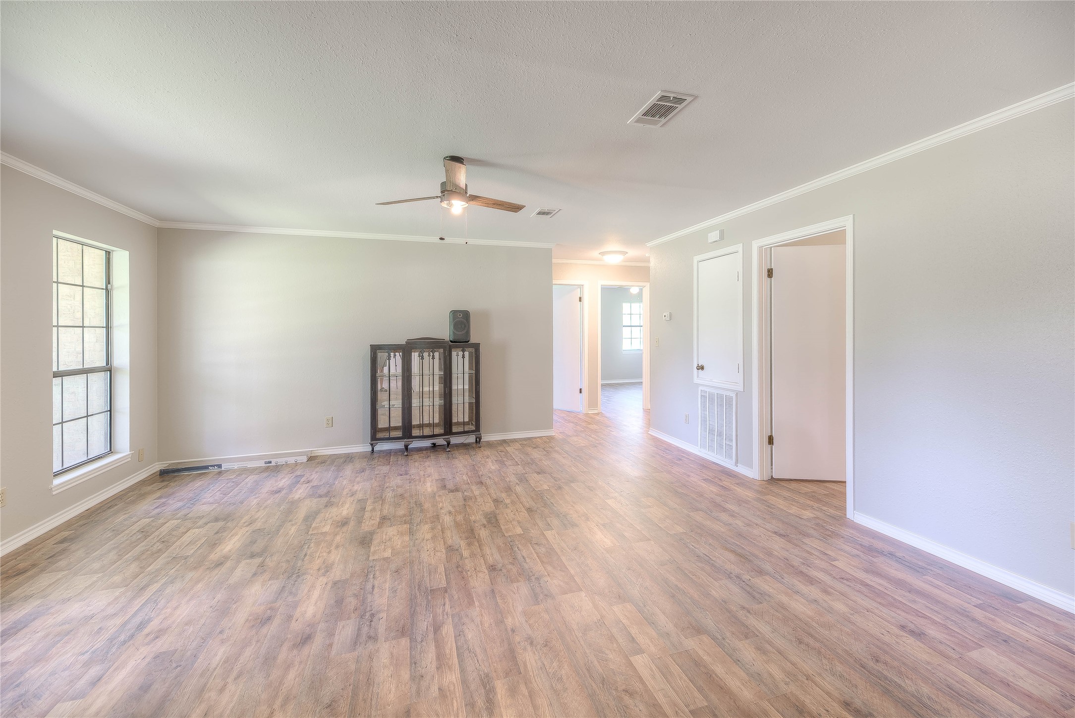 438 Bird Road Livingston, TX 77351 - Photo 5 of 37 an empty room with wooden floor and windows