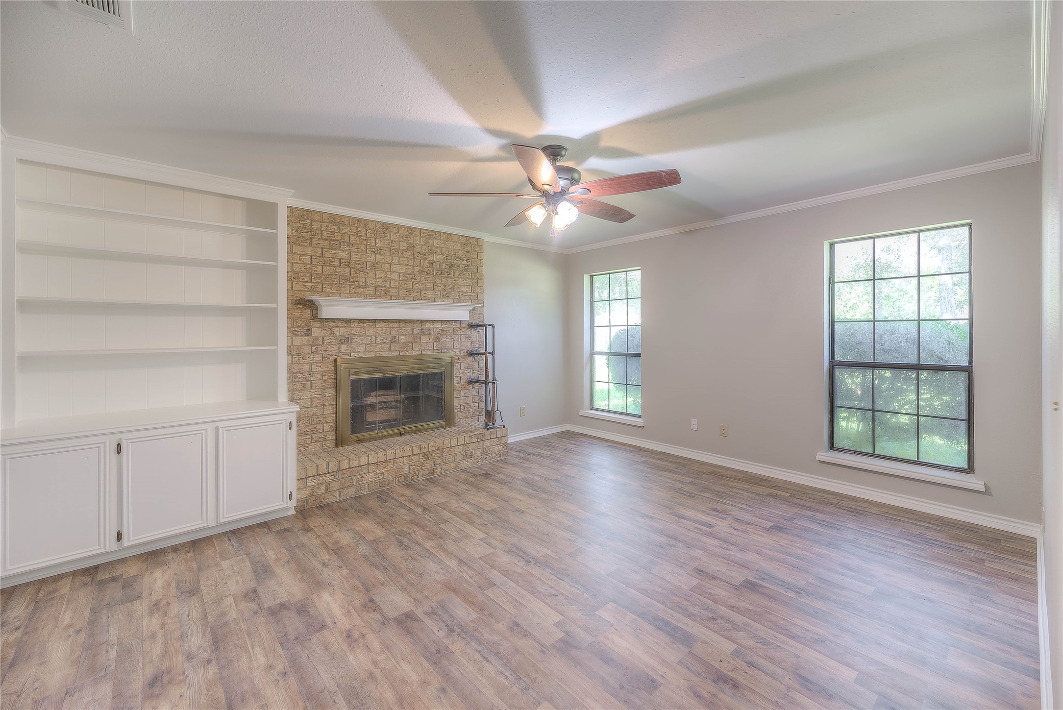 438 Bird Road Livingston, TX 77351 - Photo 7 of 37 wooden floor fireplace and windows in an empty room