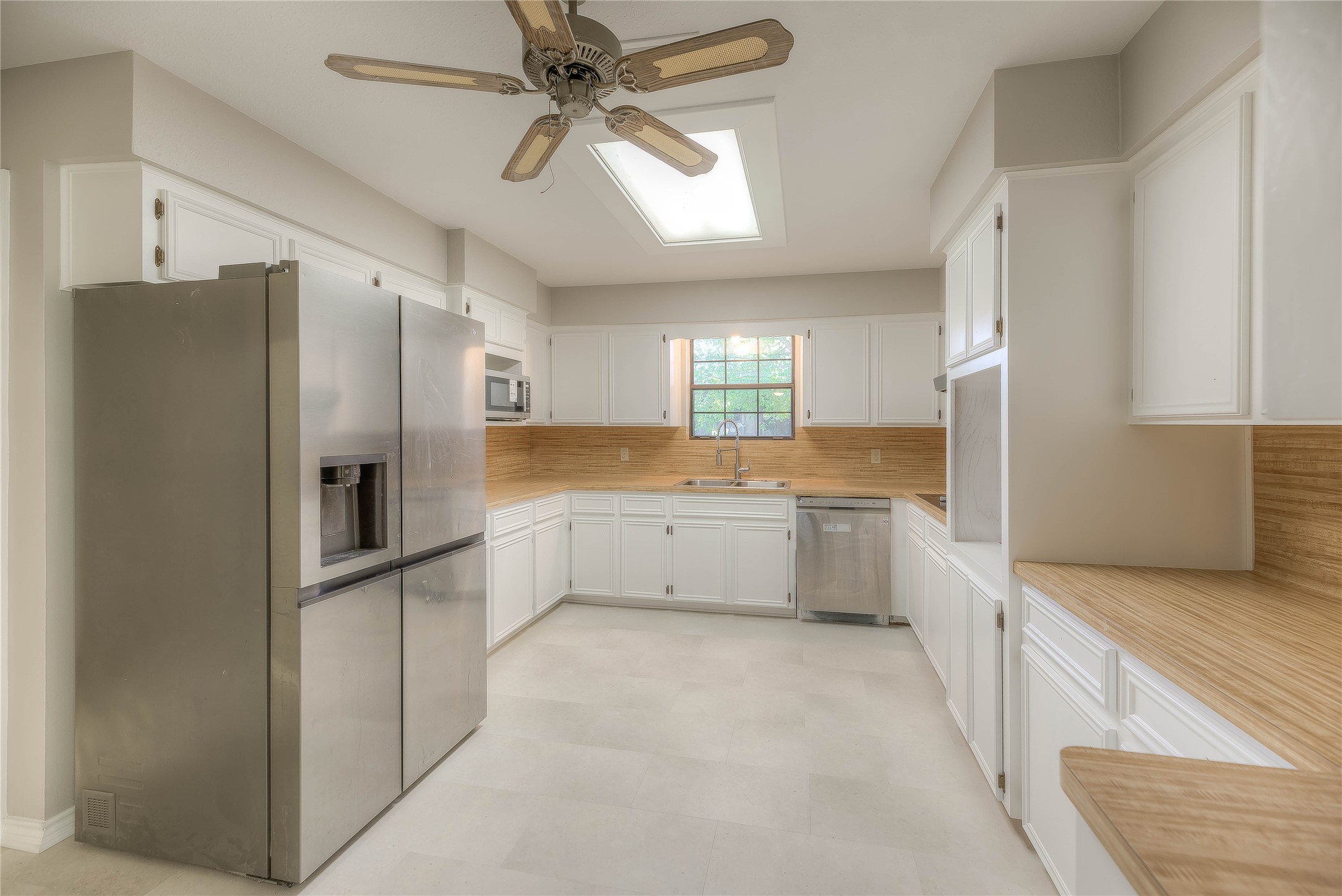 438 Bird Road Livingston, TX 77351 - Photo 9 of 37 a large kitchen with a refrigerator and a sink