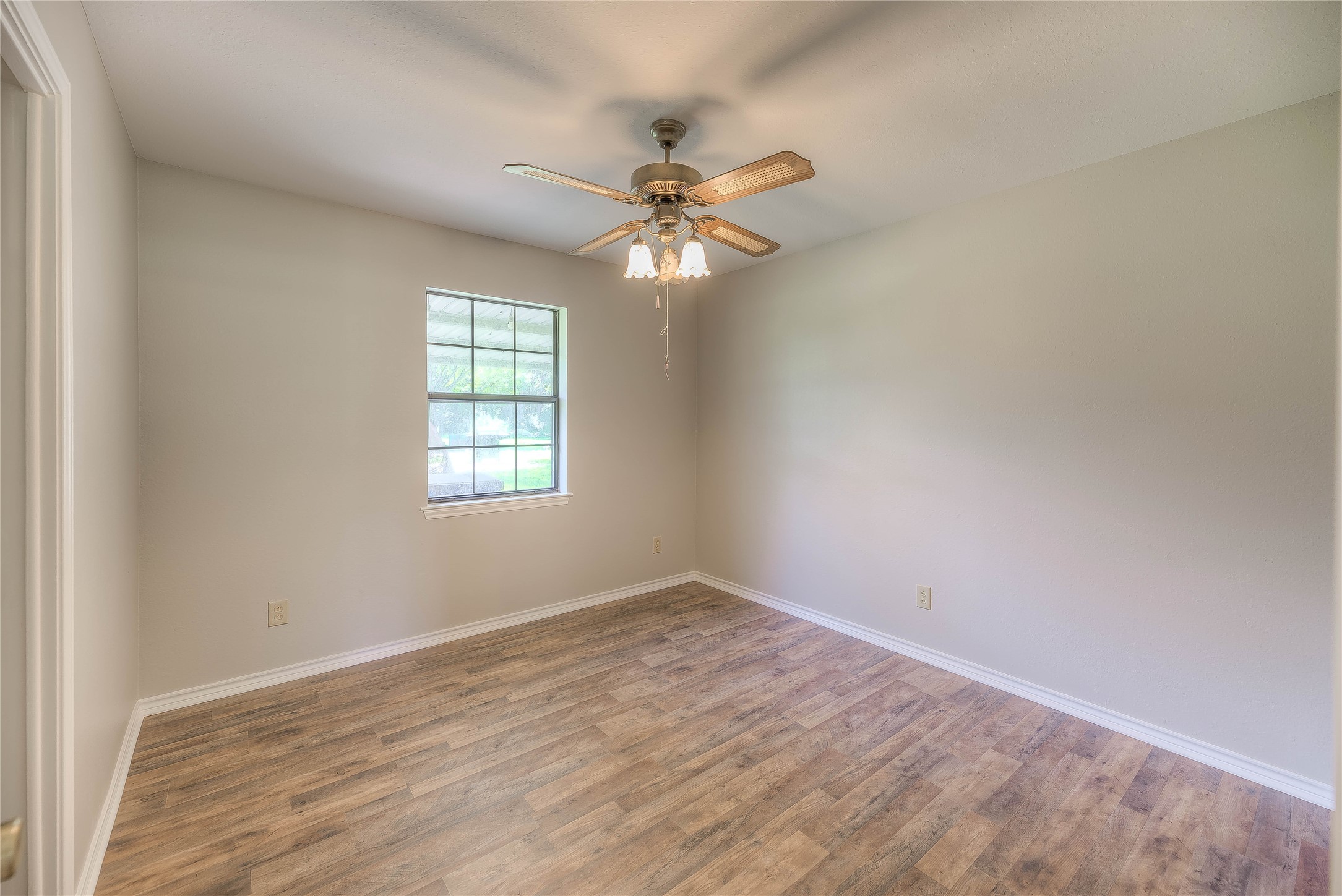 438 Bird Road Livingston, TX 77351 - Photo 10 of 37 wooden floor in an empty room with a window
