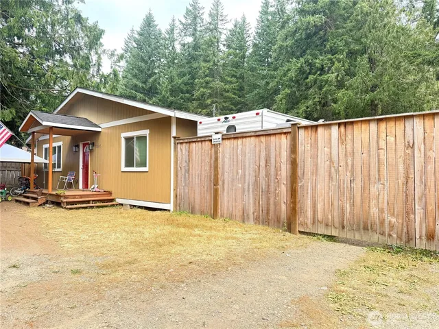 a backyard of a house with table and chairs