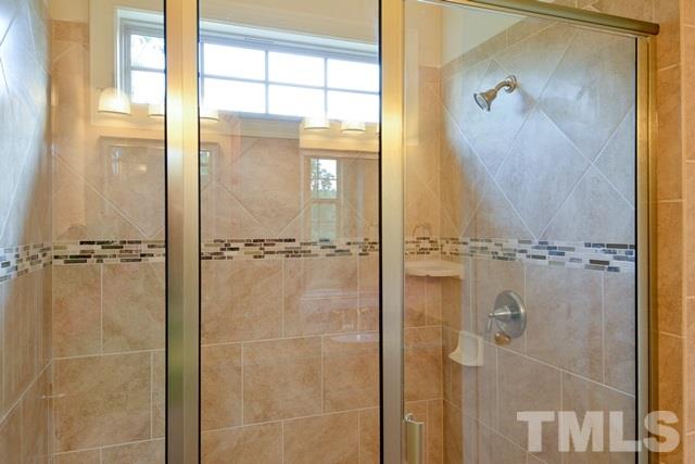 75 Whistling Straight Road, Unit 69 Pinehurst, NC 28374 - Photo 9 of 20 The glass enclosed Master Bath Shower includes details such as decorative tile, a high window, and a built-in bench.