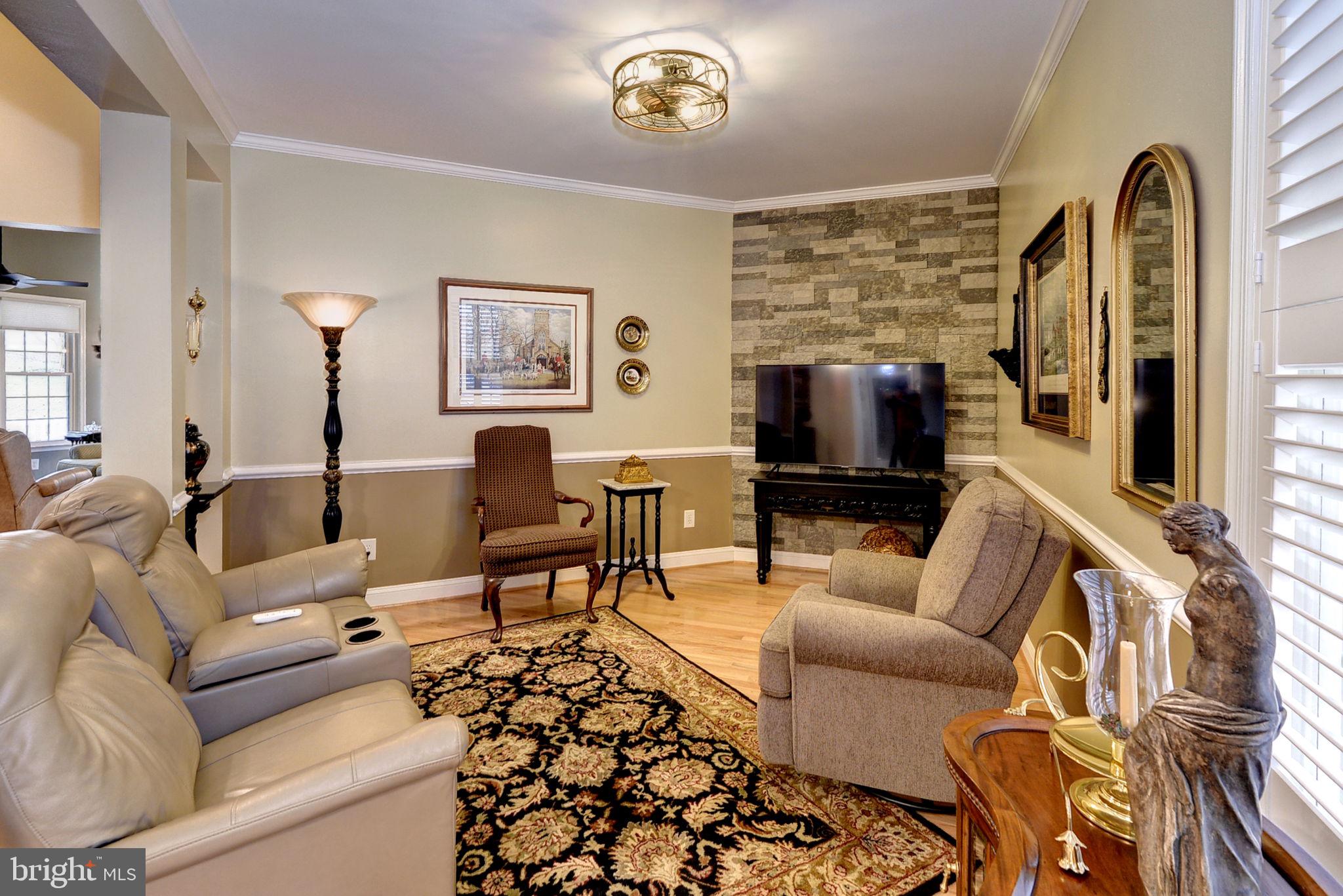 7100 Pinebrook Road Williamsburg, VA 23188 - Photo 11 of 86 a living room with furniture and a flat screen tv