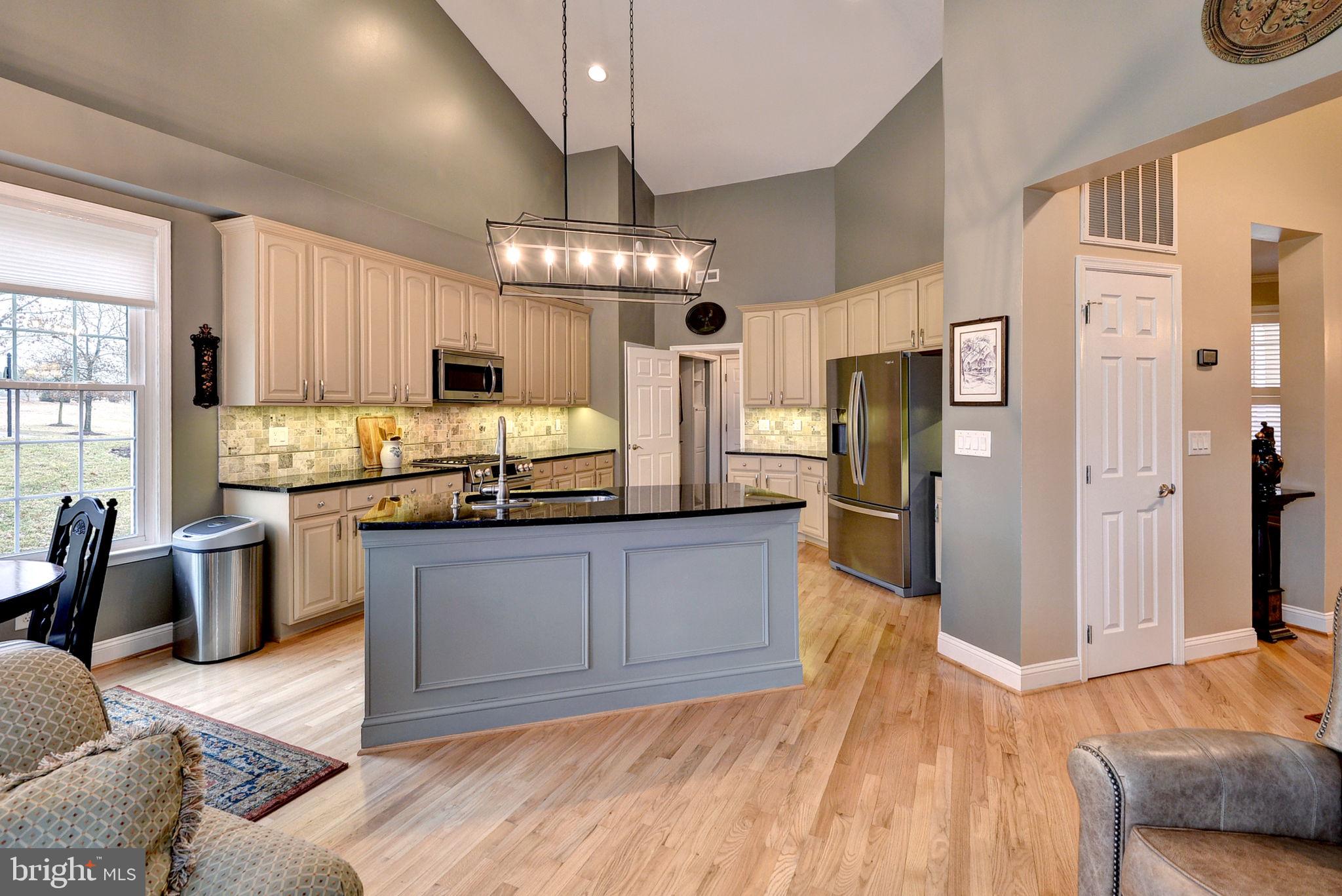 7100 Pinebrook Road Williamsburg, VA 23188 - Photo 22 of 86 a kitchen with stainless steel appliances granite countertop a refrigerator a sink dishwasher a stove and white cabinets with wooden floor
