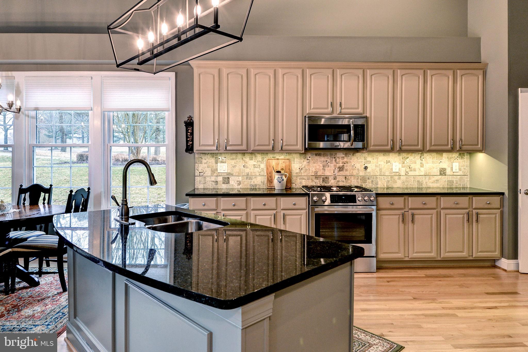 7100 Pinebrook Road Williamsburg, VA 23188 - Photo 24 of 86 a kitchen with granite countertop a sink stainless steel appliances and cabinets