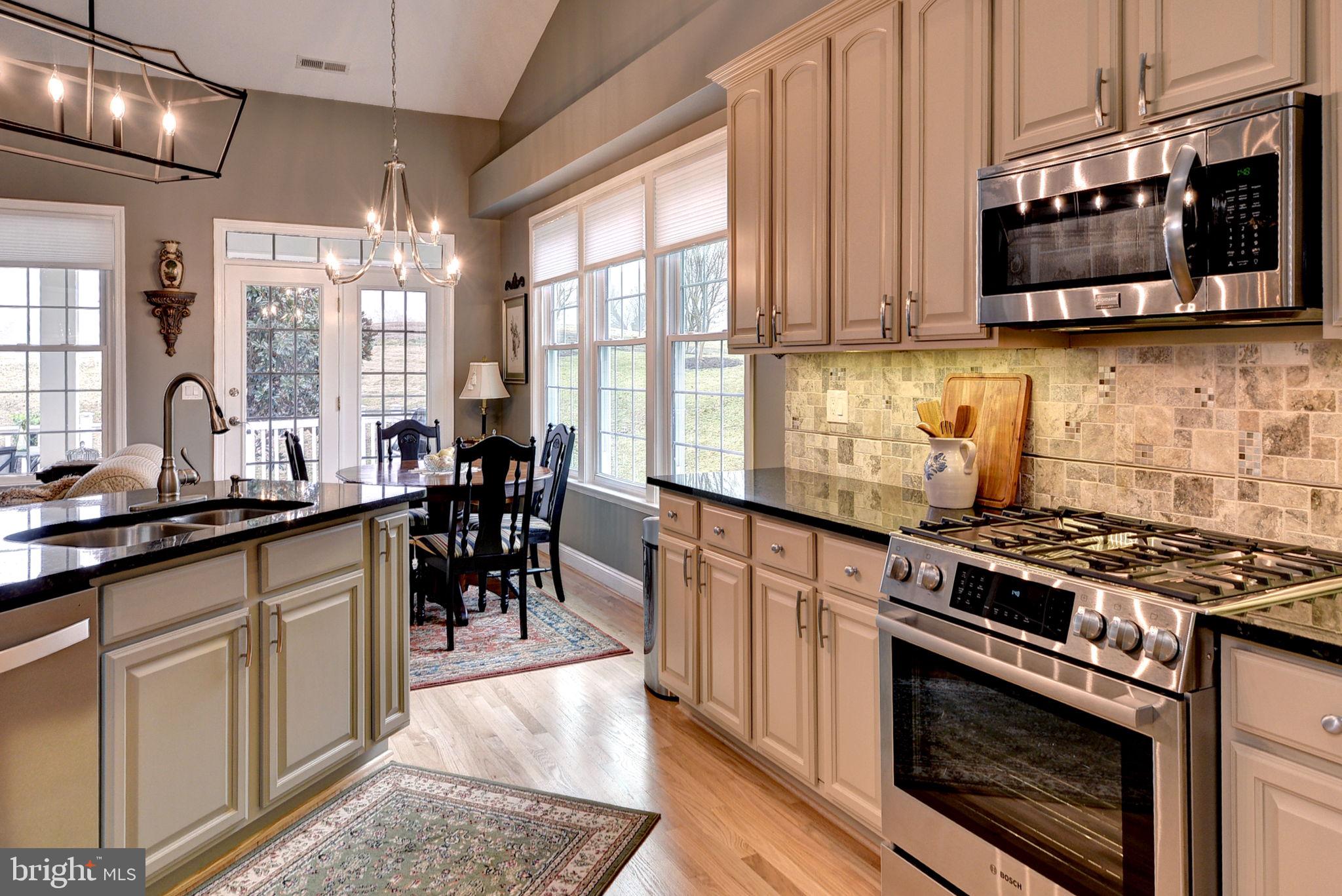 7100 Pinebrook Road Williamsburg, VA 23188 - Photo 28 of 86 a kitchen with stainless steel appliances granite countertop a stove a sink and a microwave