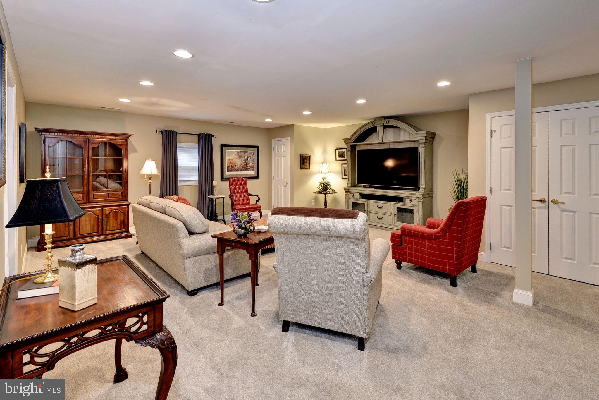 7100 Pinebrook Road Williamsburg, VA 23188 - Photo 41 of 86 a living room with furniture and a flat screen tv