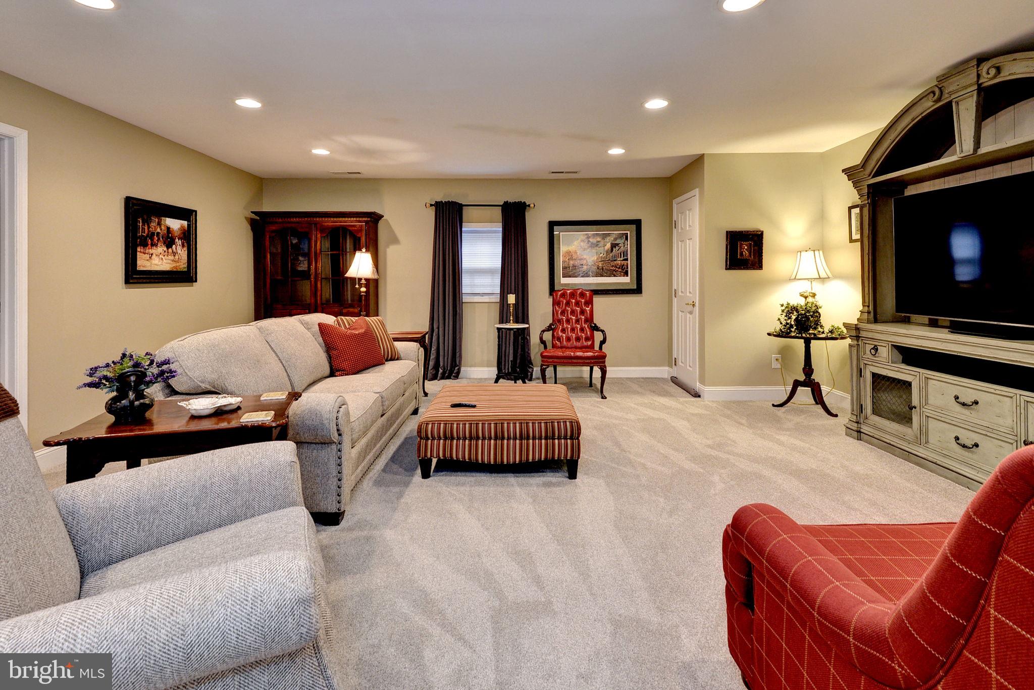 7100 Pinebrook Road Williamsburg, VA 23188 - Photo 42 of 86 a living room with furniture and a flat screen tv