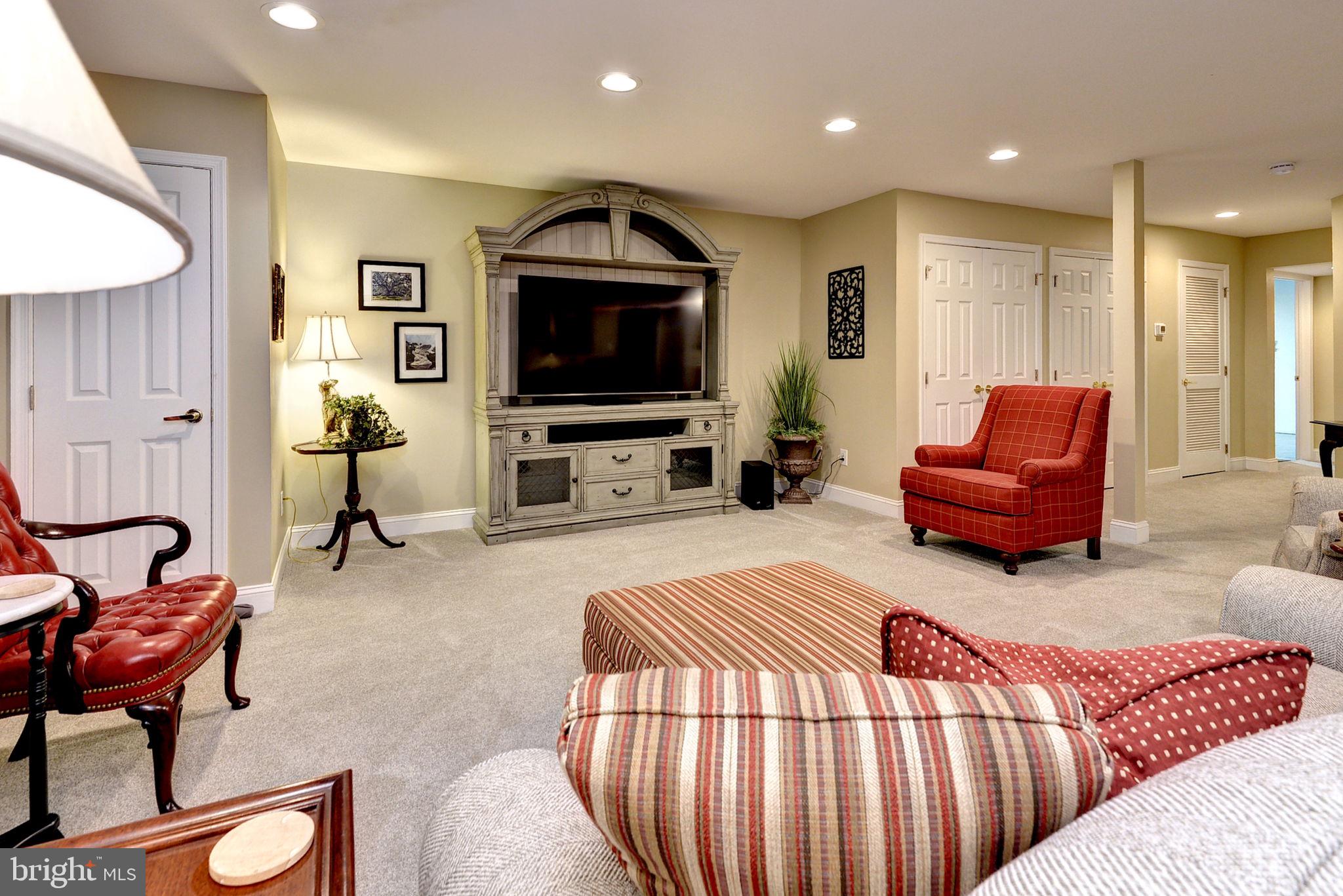 7100 Pinebrook Road Williamsburg, VA 23188 - Photo 43 of 86 a living room with furniture and a flat screen tv
