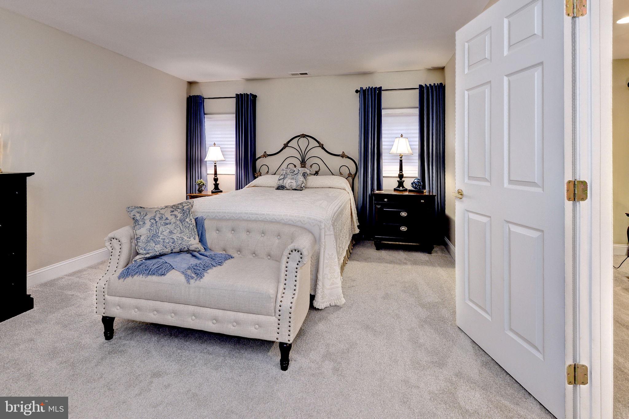 7100 Pinebrook Road Williamsburg, VA 23188 - Photo 44 of 86 a bedroom with a bed window and a night stand