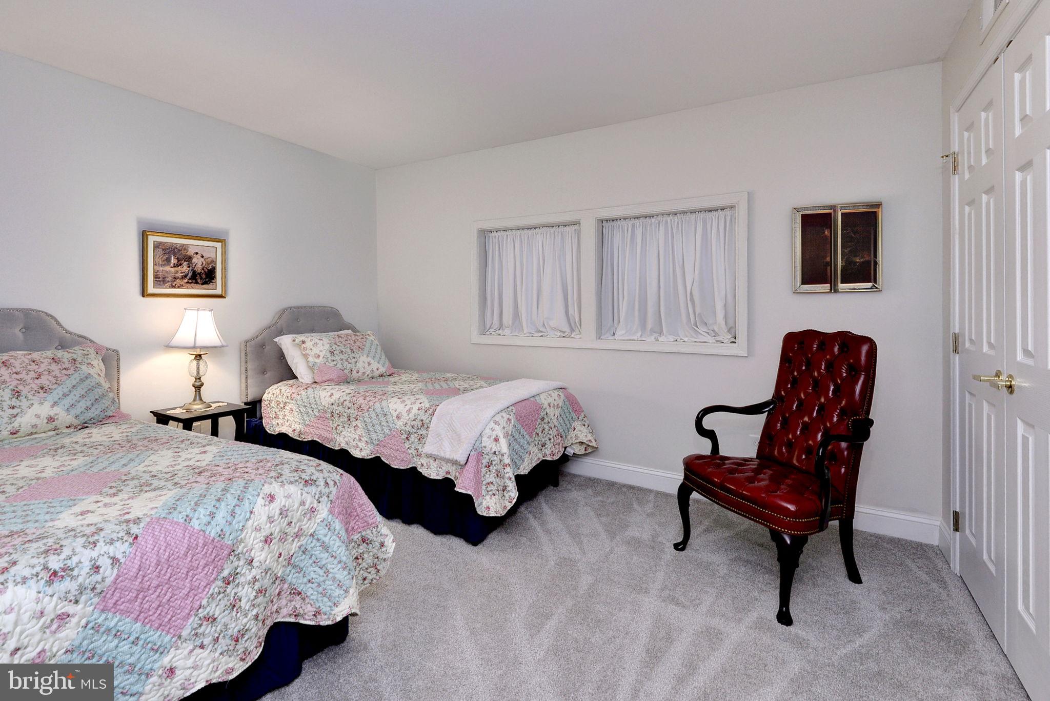 7100 Pinebrook Road Williamsburg, VA 23188 - Photo 46 of 86 a bedroom with two beds and a chair