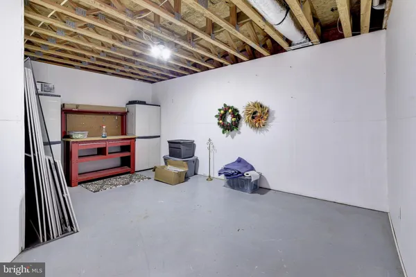 a view of a livingroom with furniture and a bookshelf