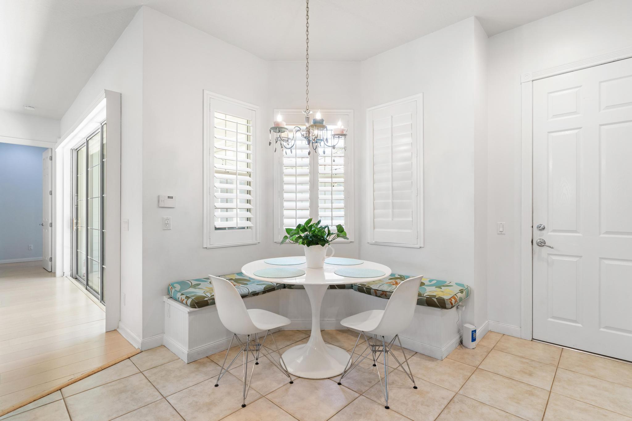 3446 West Mallory Boulevard Jupiter, FL 33458 - Photo 19 of 56 a view of a dining room with furniture and window