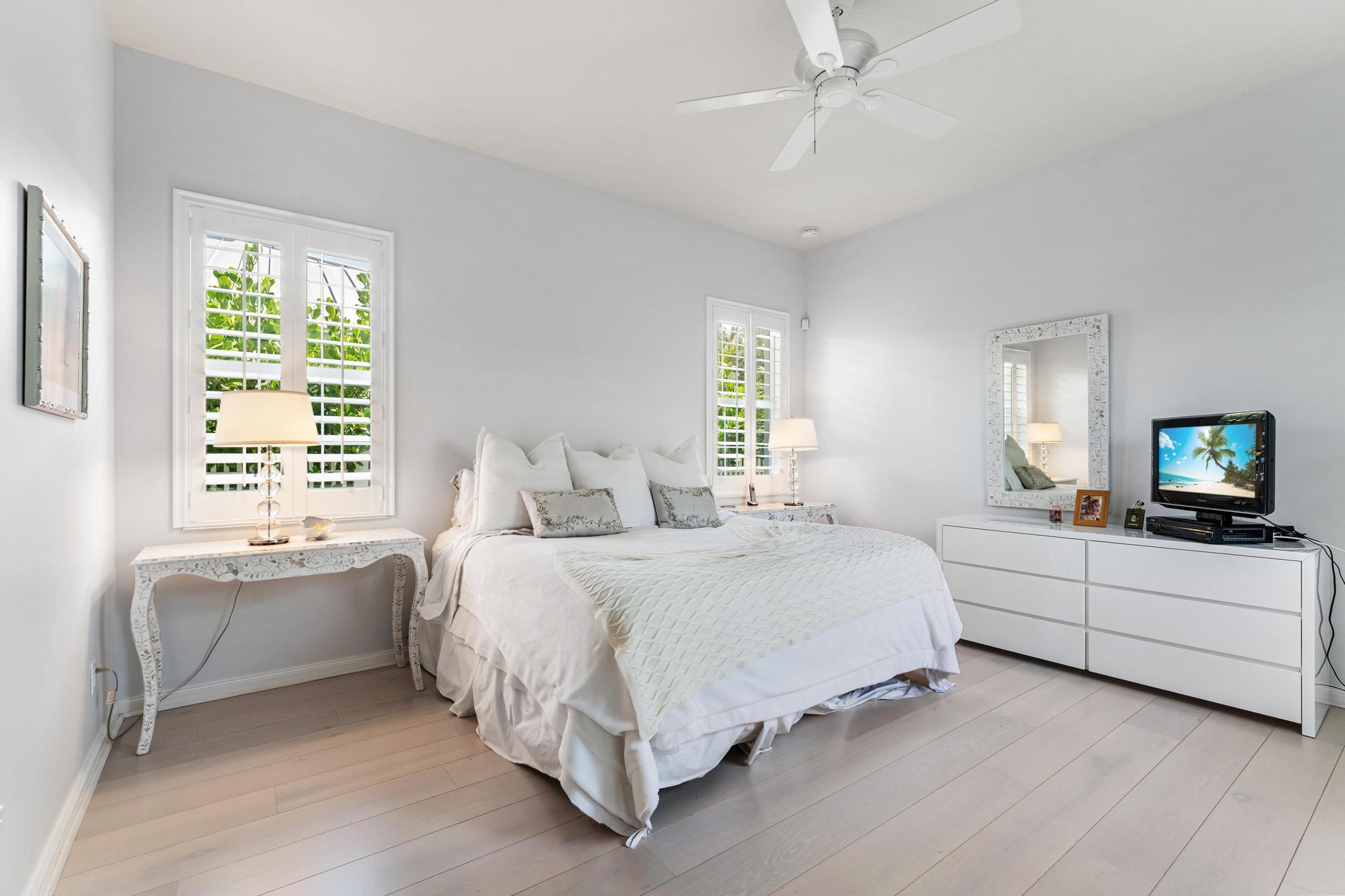 3446 West Mallory Boulevard Jupiter, FL 33458 - Photo 23 of 56 a spacious bedroom with a bed and a couch