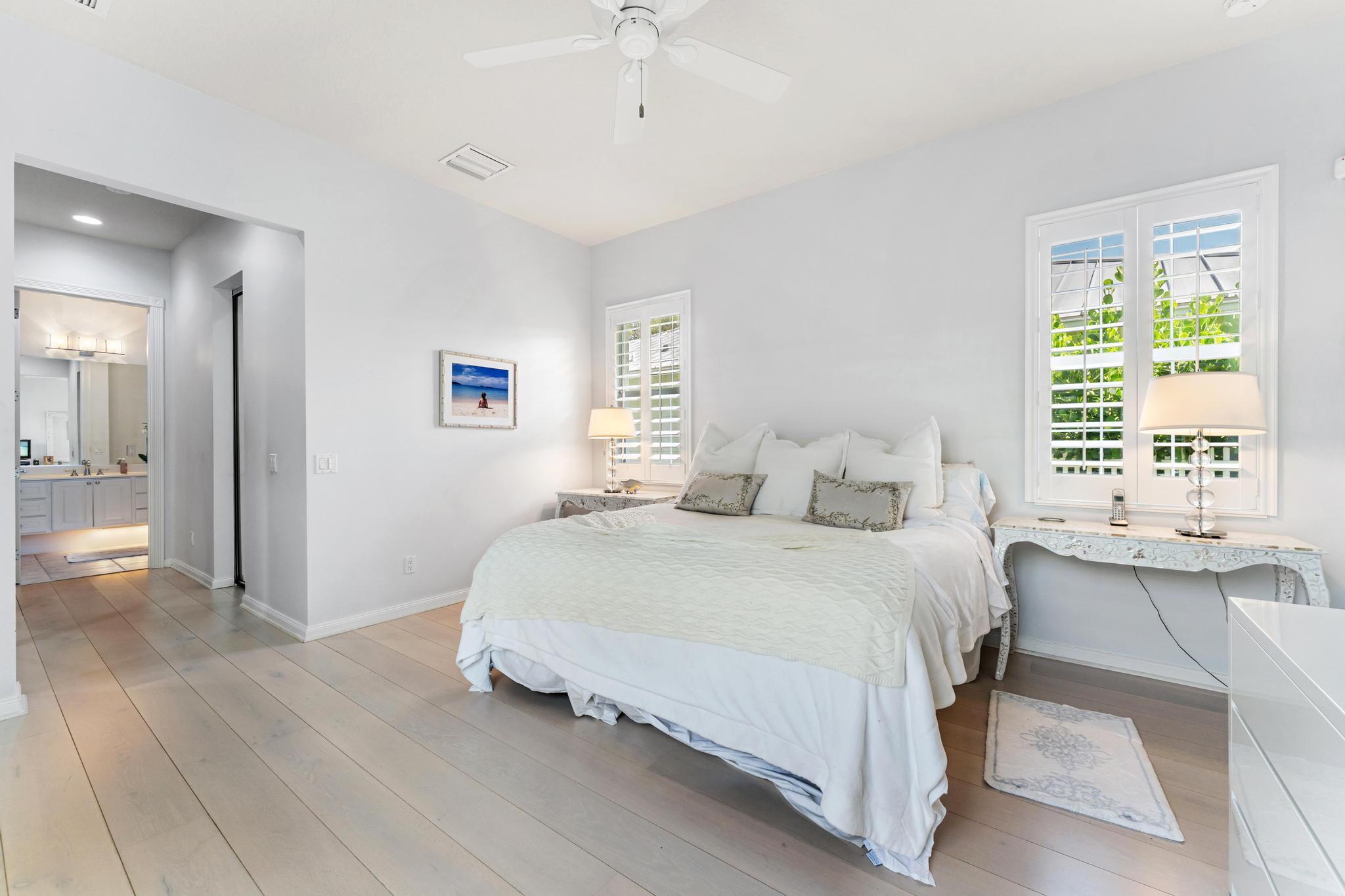 3446 West Mallory Boulevard Jupiter, FL 33458 - Photo 24 of 56 a spacious bedroom with a bed and a table