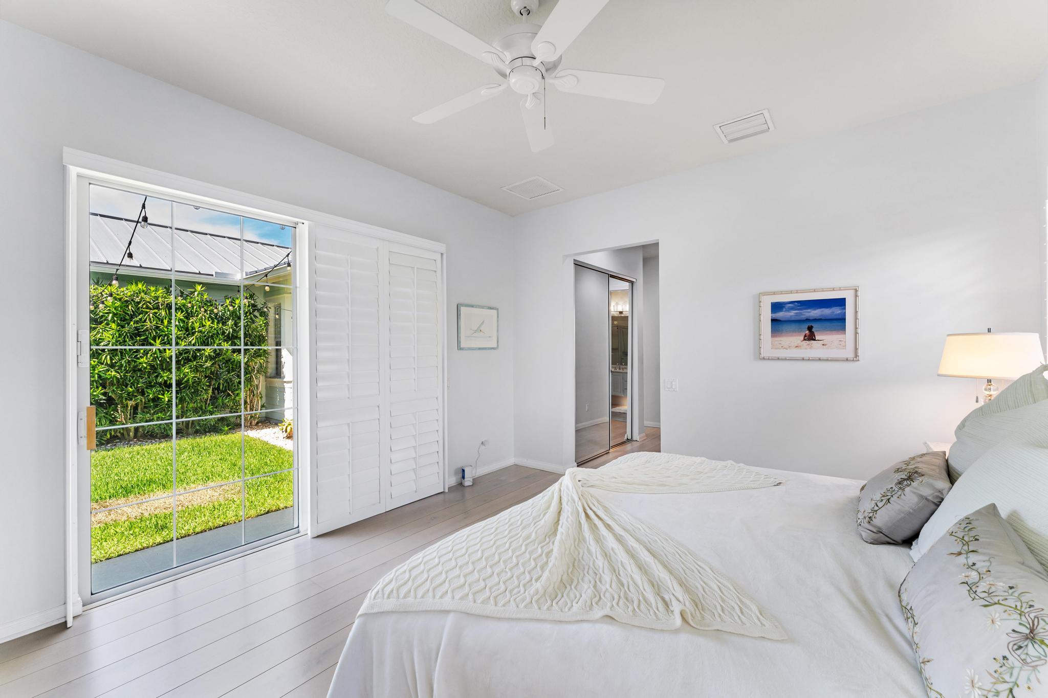 3446 West Mallory Boulevard Jupiter, FL 33458 - Photo 25 of 56 a bedroom with a bed and a large window