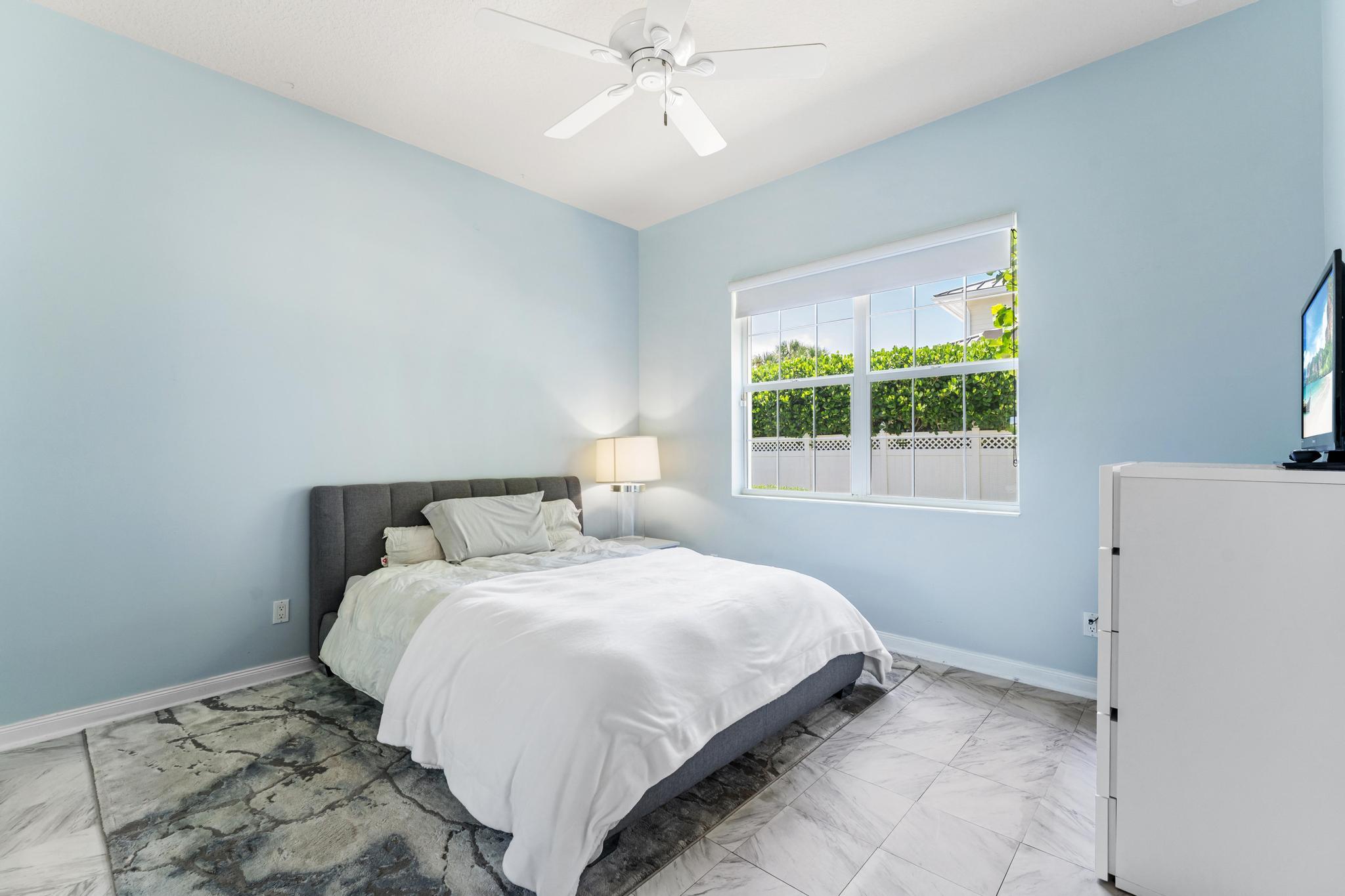 3446 West Mallory Boulevard Jupiter, FL 33458 - Photo 27 of 56 a bedroom with a bed and a window