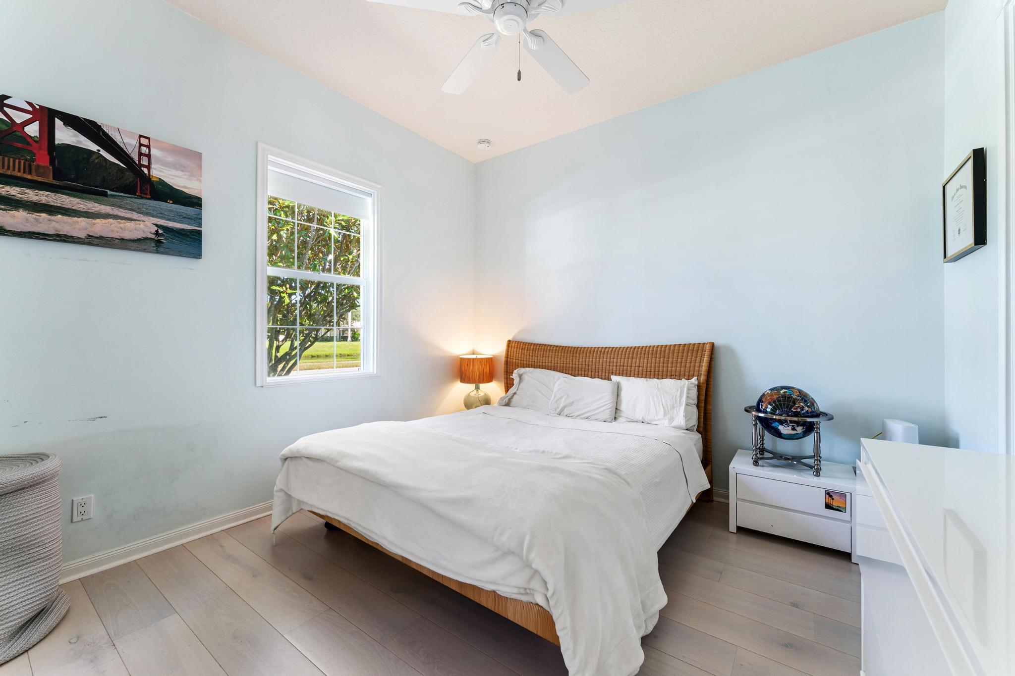 3446 West Mallory Boulevard Jupiter, FL 33458 - Photo 31 of 56 a bedroom with a bed and a window