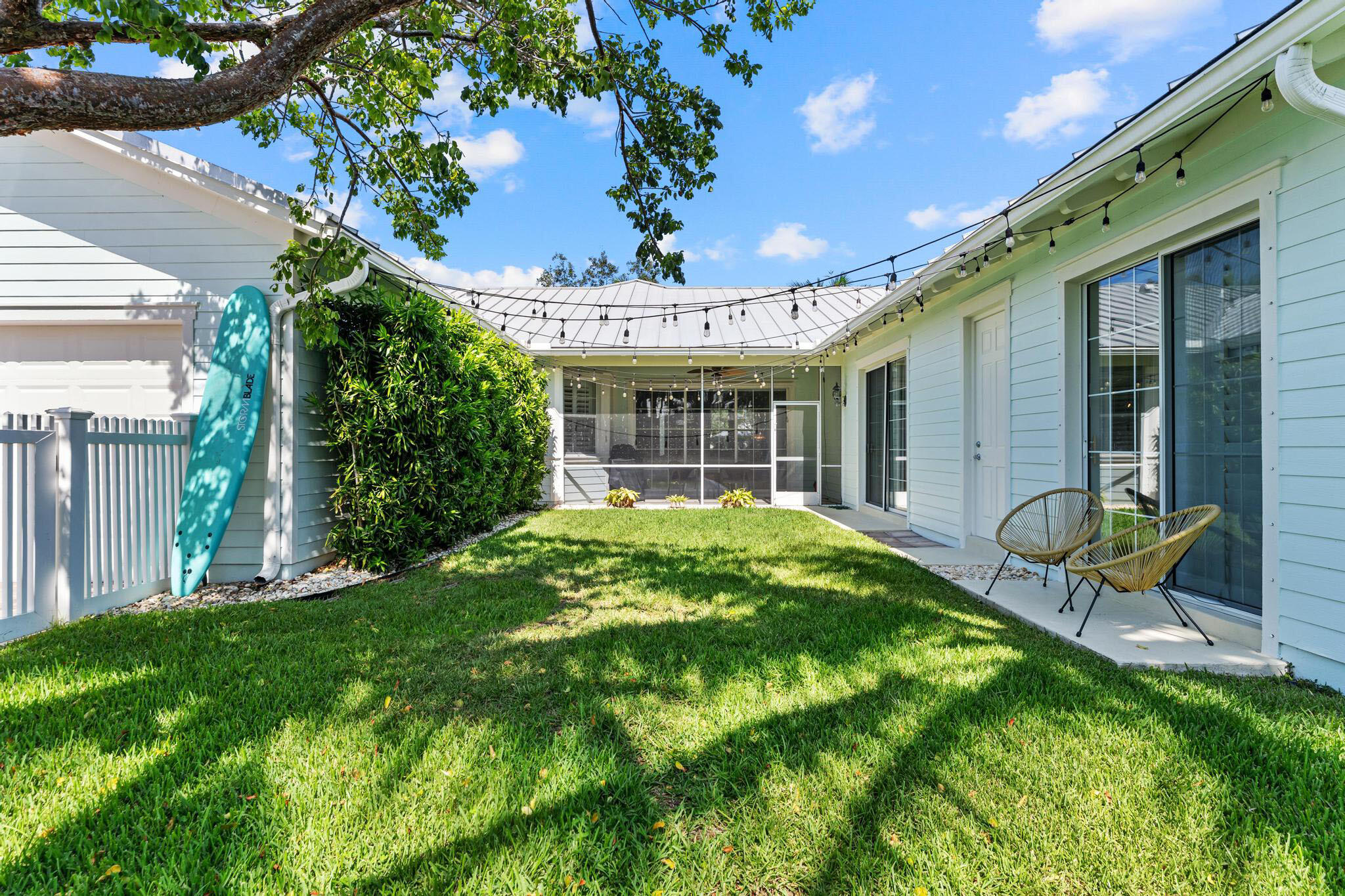 3446 West Mallory Boulevard Jupiter, FL 33458 - Photo 40 of 56 a view of an house with backyard porch and sitting area