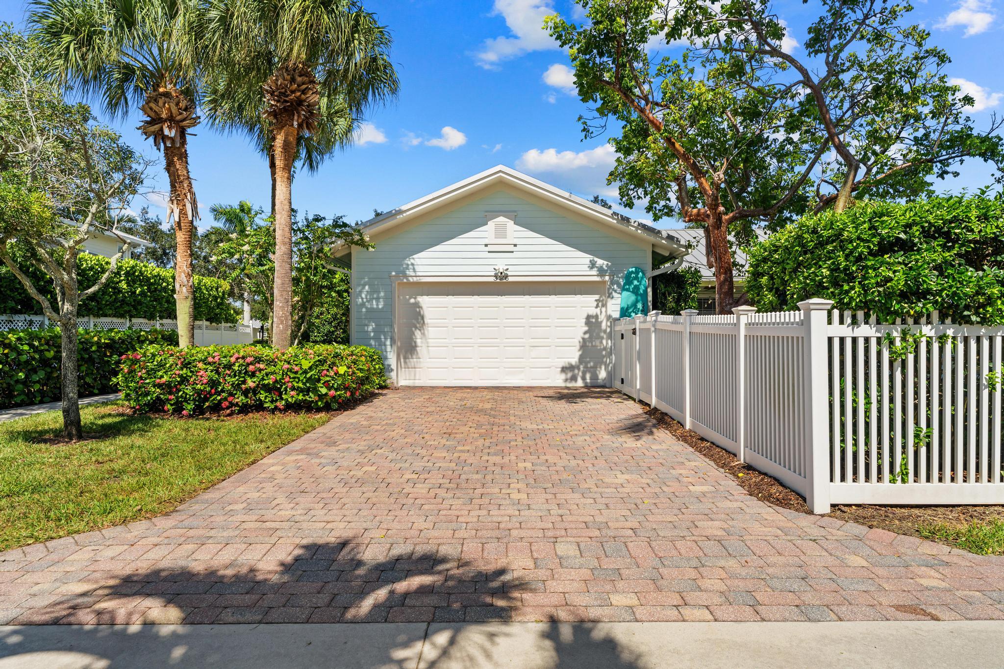 3446 West Mallory Boulevard Jupiter, FL 33458 - Photo 43 of 56 a front view of a house with a yard and garage