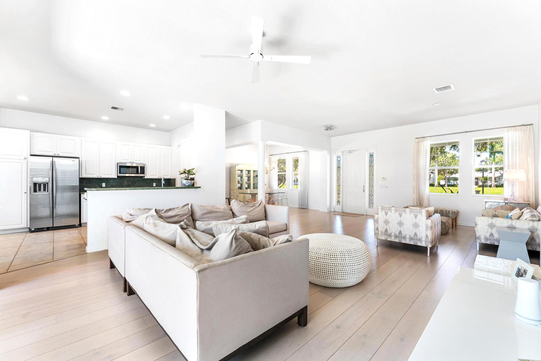 3446 West Mallory Boulevard Jupiter, FL 33458 - Photo 9 of 56 a living room with furniture and a large window