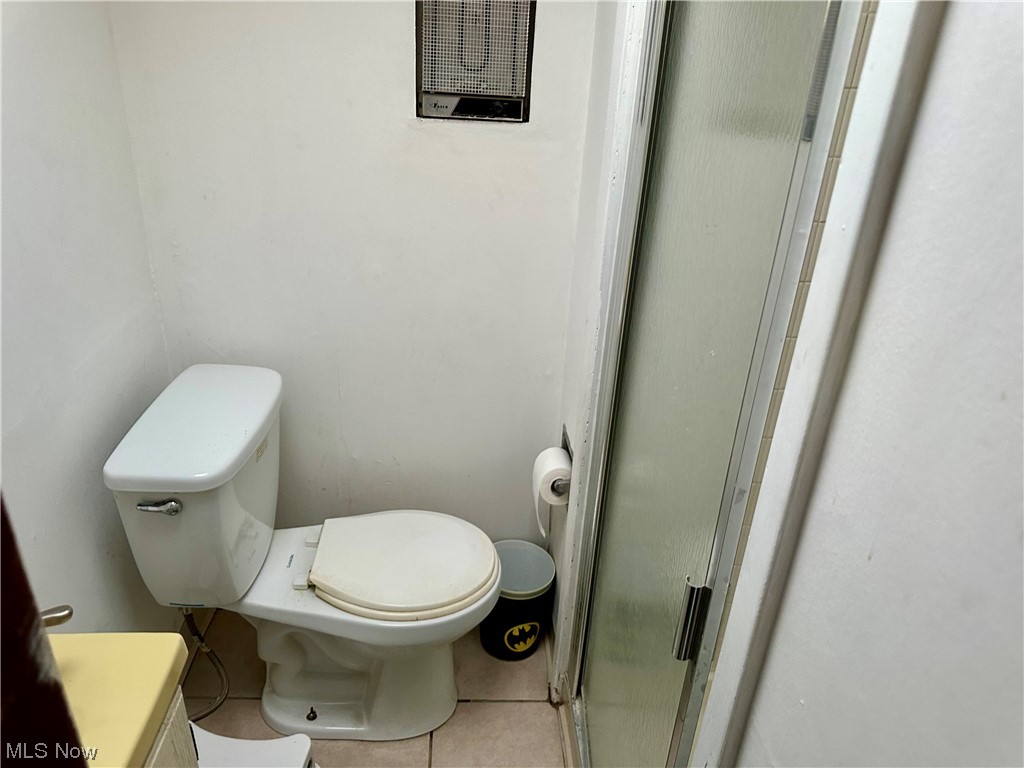 4197 Lambert Road Cleveland, OH 44121 - Photo 8 of 13 Bathroom featuring vanity, toilet, an enclosed shower, and tile flooring