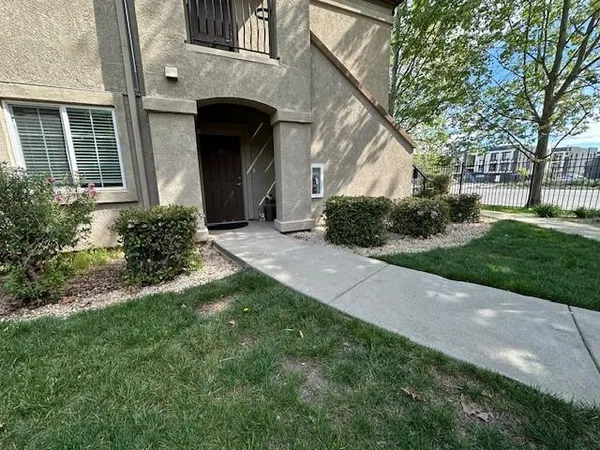 a view of a front of a house with a yard