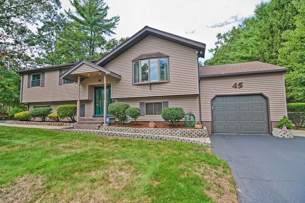 45 Frank Road Stoughton, MA 02072 - Photo 1 of 41 a front view of a house with a yard and garage