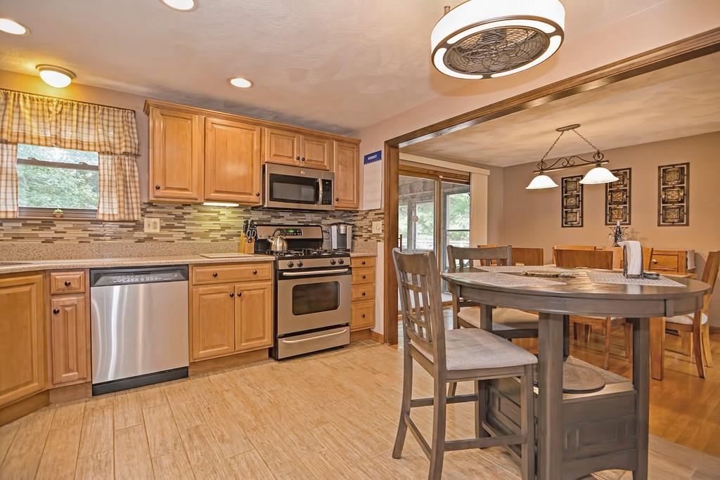 45 Frank Road Stoughton, MA 02072 - Photo 2 of 41 a kitchen with stainless steel appliances granite countertop a stove a sink dishwasher and a microwave oven with wooden floor