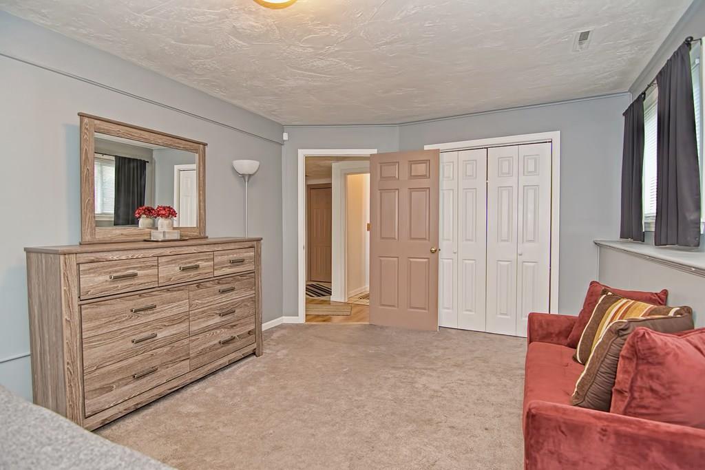 45 Frank Road Stoughton, MA 02072 - Photo 27 of 41 a living room with furniture and a dresser