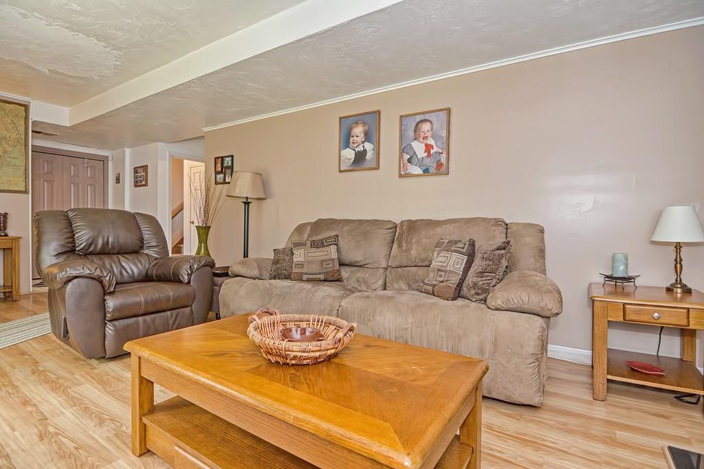 45 Frank Road Stoughton, MA 02072 - Photo 30 of 41 a living room with furniture and a wooden floor