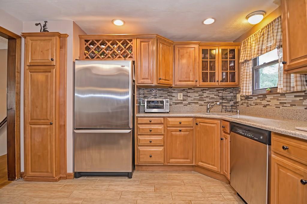 45 Frank Road Stoughton, MA 02072 - Photo 8 of 41 a kitchen with granite countertop stainless steel appliances a refrigerator and cabinets