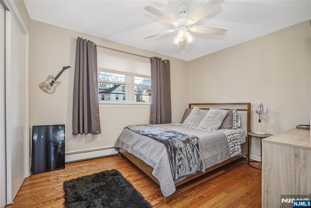 12 Maple Avenue, Unit A Waldwick, NJ 07463 - Photo 11 of 22 a bedroom with a large bed and a chandelier