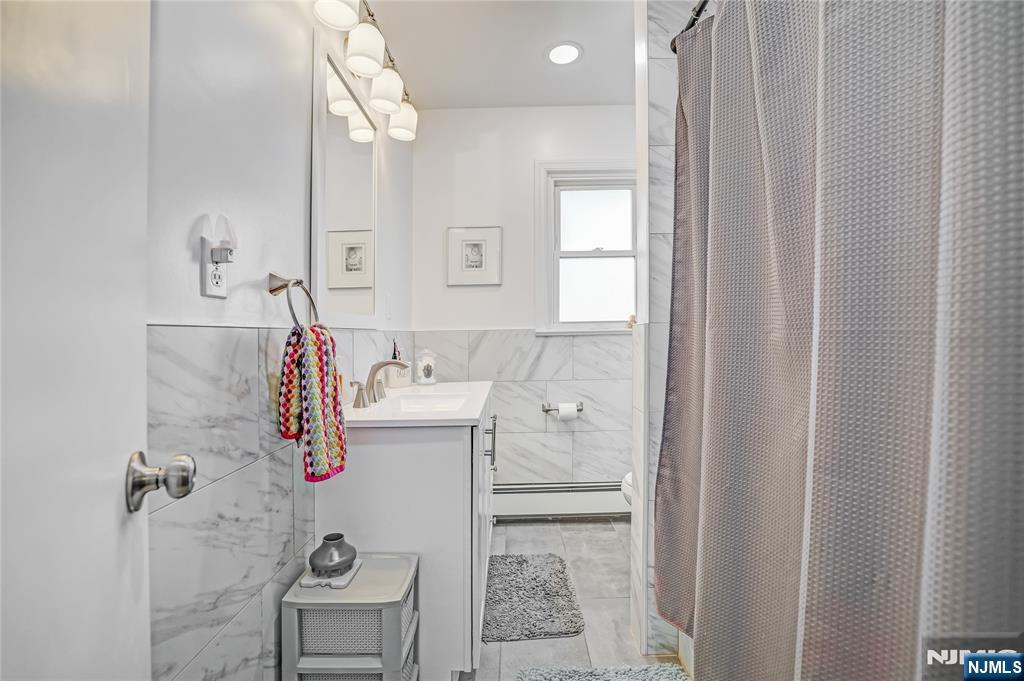 12 Maple Avenue, Unit A Waldwick, NJ 07463 - Photo 13 of 22 a bathroom with a sink vanity and toilet