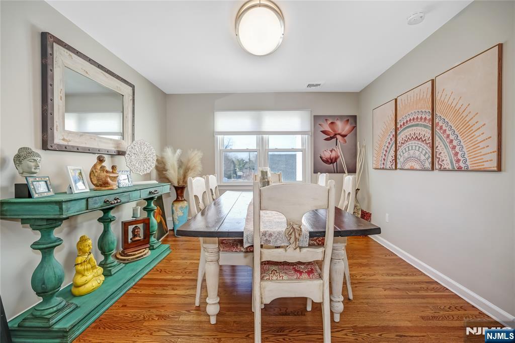 12 Maple Avenue, Unit A Waldwick, NJ 07463 - Photo 5 of 22 a view of a dining room with furniture a chandelier and wooden floor