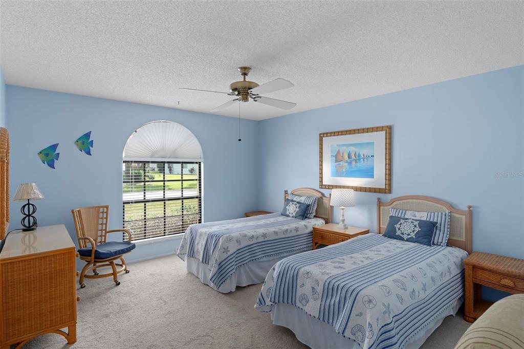 6421 Pine Meadows Drive Spring Hill, FL 34606 - Photo 25 of 61 a bedroom with two beds and a window
