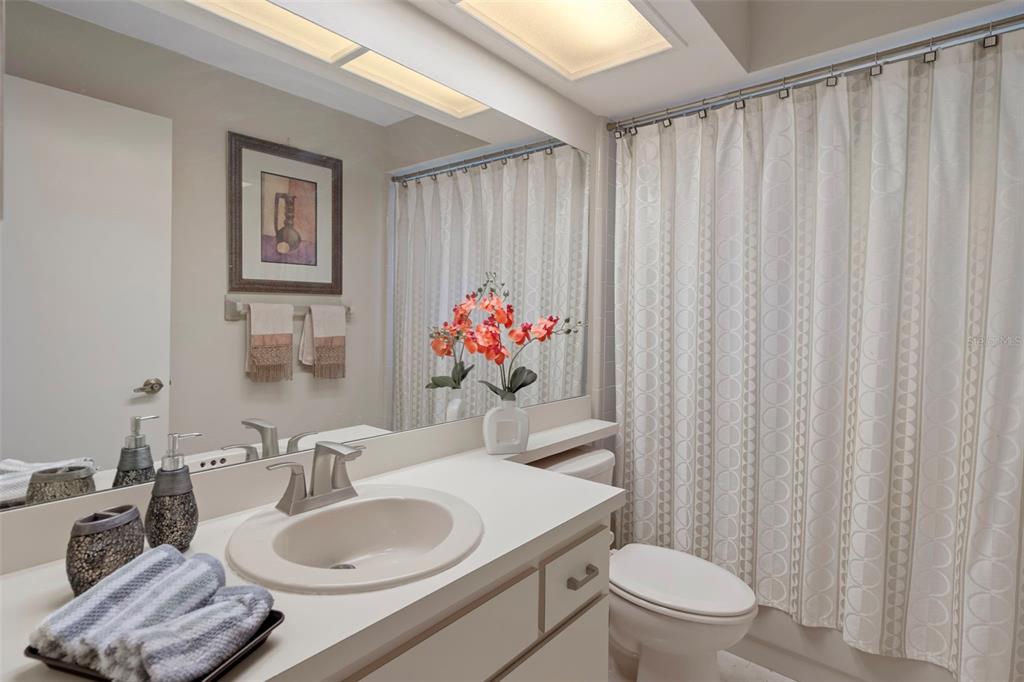 6421 Pine Meadows Drive Spring Hill, FL 34606 - Photo 27 of 61 a bathroom with a toilet a sink and a mirror