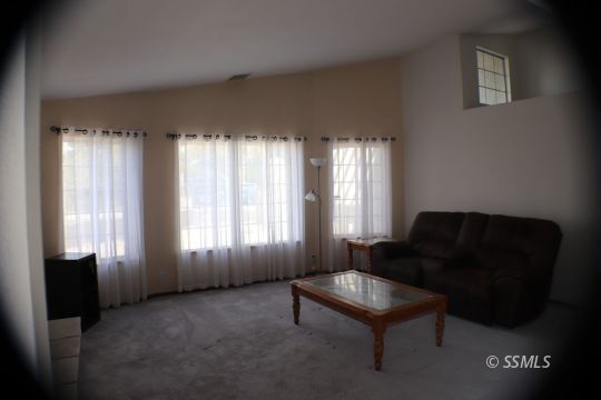 425 Veada Avenue Ridgecrest, CA 93555 - Photo 11 of 35 a living room with furniture and a window